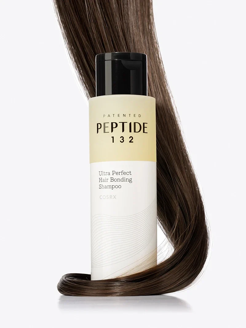Cosrx Peptide-132 Shampoo surrounded by a coil of dark, healthy hair