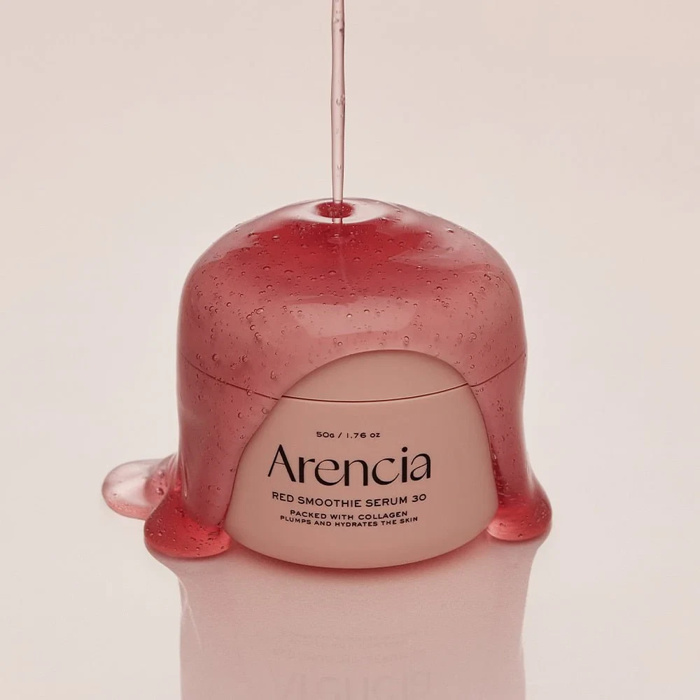 Arencia Red Smoothie Serum 30 covered in spilt, rosy serum