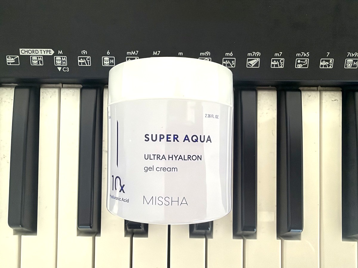 Missha Super Aqua Ultra Hyalron Gel Cream jar, 10x hyaluronic acid, resting on piano keys