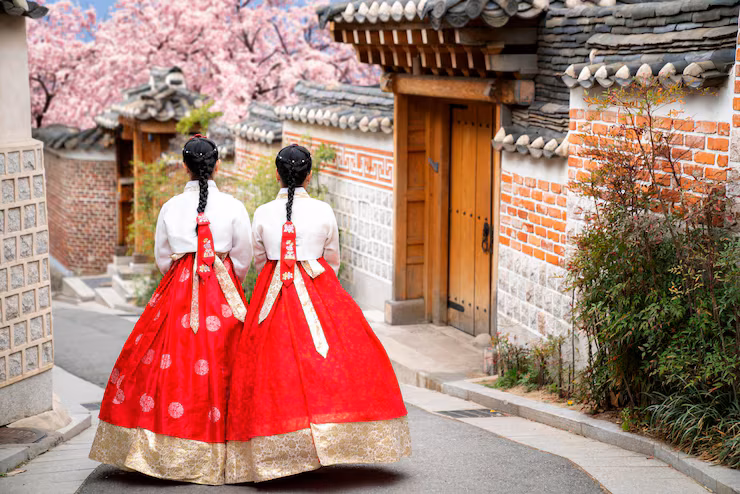 Two women dressed in traditional Hanbok in old-school South Korean roads