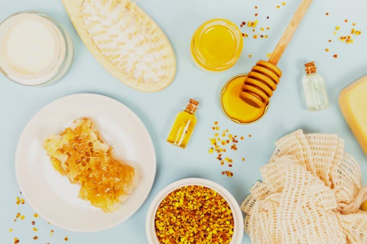 Skincare routine set out (with hairbrush, honeycomb, honey serum and loofah)