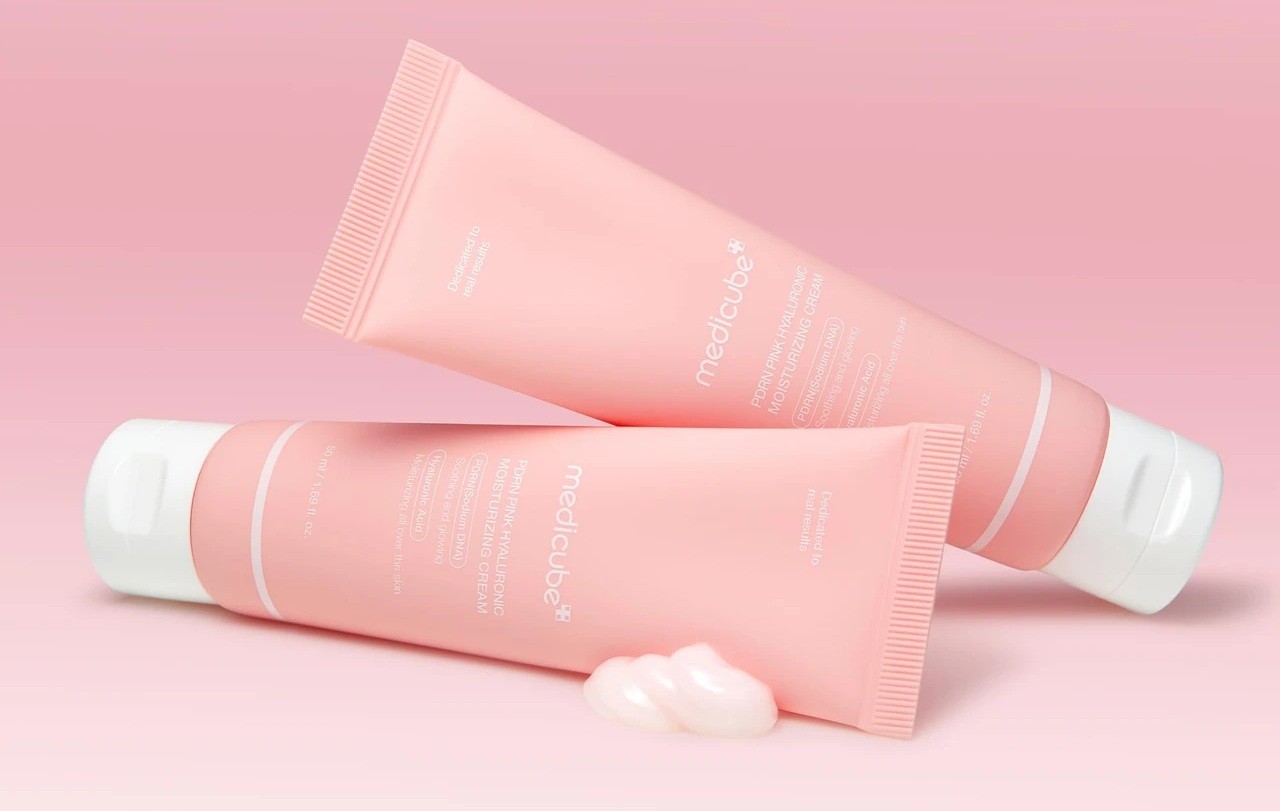 Medicube PDRN Pink Hyaluronic Acid Moisturizing Cream bottle reclined on another bottle
