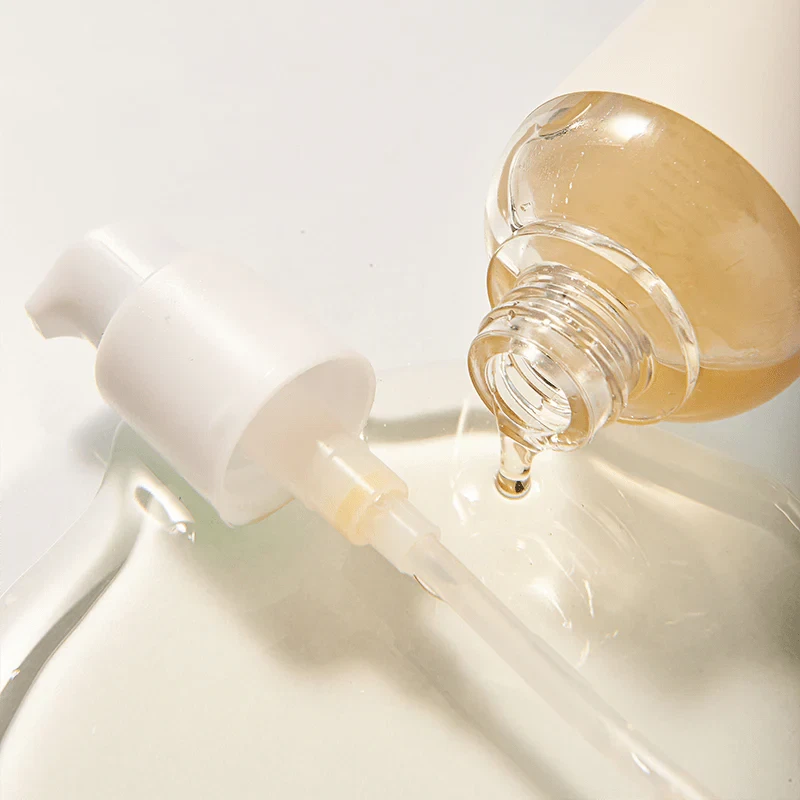 Mixsoon Bean Essence bottle open and pouring onto white background.