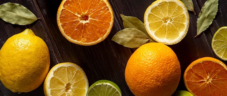 Cut cross-section of various citrus fruits, including lemons, orange, grapefruit and lime