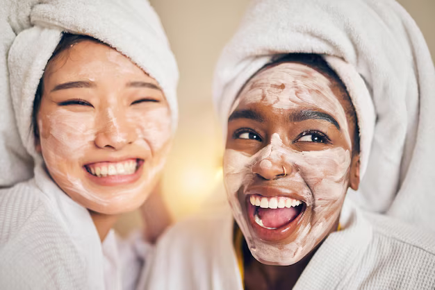 Two friends adding a pore mask to their skin together