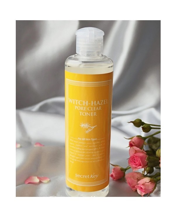 Secret Key Witch-Hazel Pore Clear Toner on white satin with pink roses