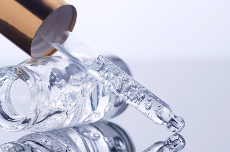 Serum bottle lying on side with applicator resting on mirrored surface