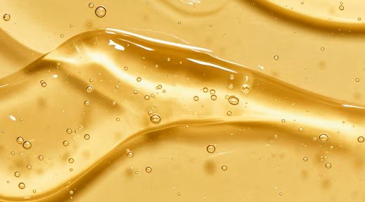 Golden yellow gel moisturizer on a plain background