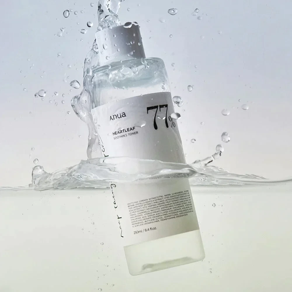 Anua Heartleaf Soothing Toner floating in water with water droplets coating it