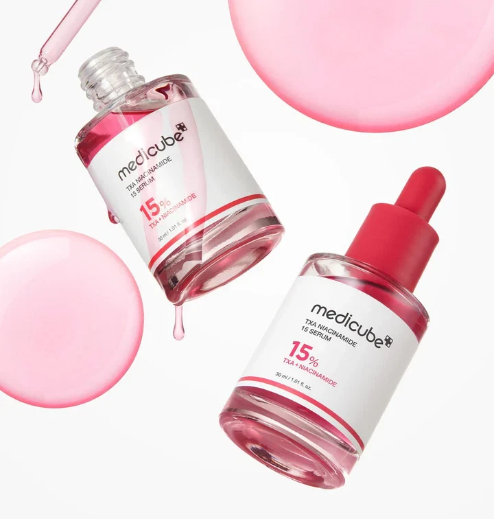 Medicube TXA Niacinamide serum with open applicator dripping pink serum