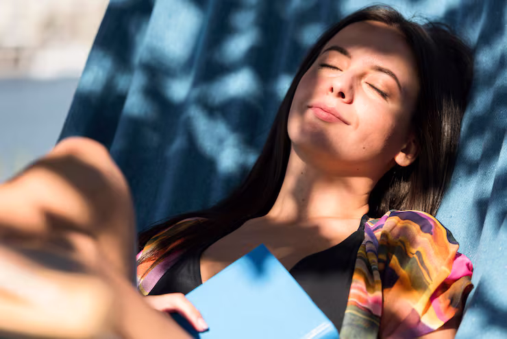 Woman reclining in a beach chair in the shade, relaxing