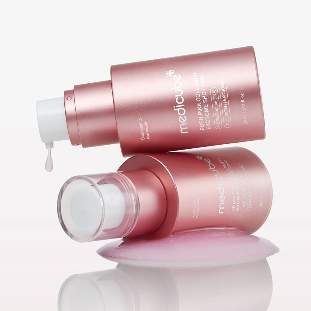 Medicube PDRN Pink Collagen Exosome Shot 2000 bottle atop a second bottle, with dripping light-pink serum