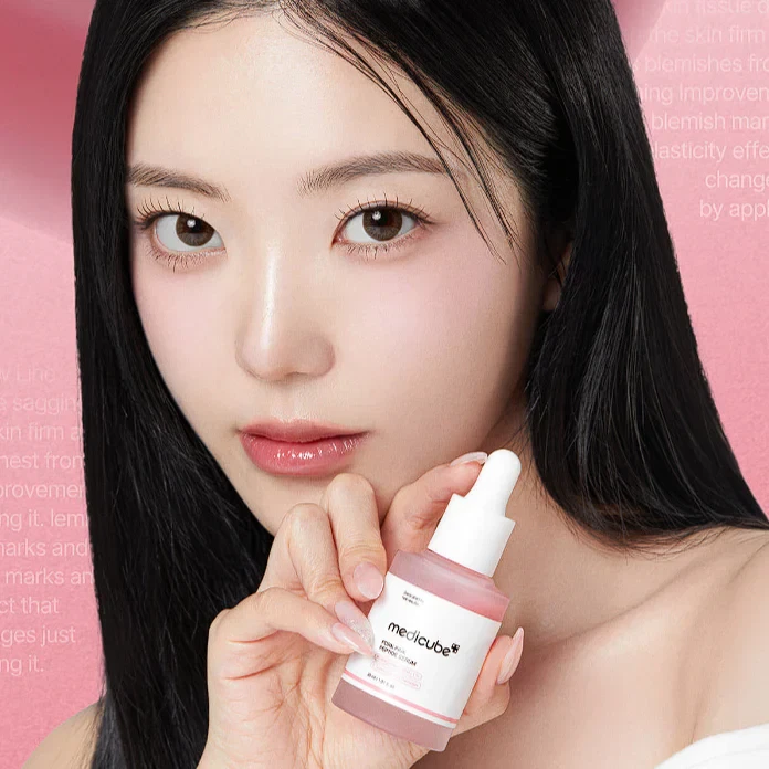 Model holding Medicube Pink PDRN Peptide Serum
