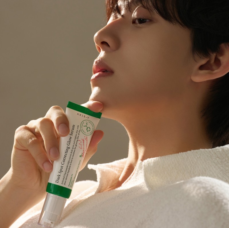 Axis Y Dark Spot Correcting Glow held by model