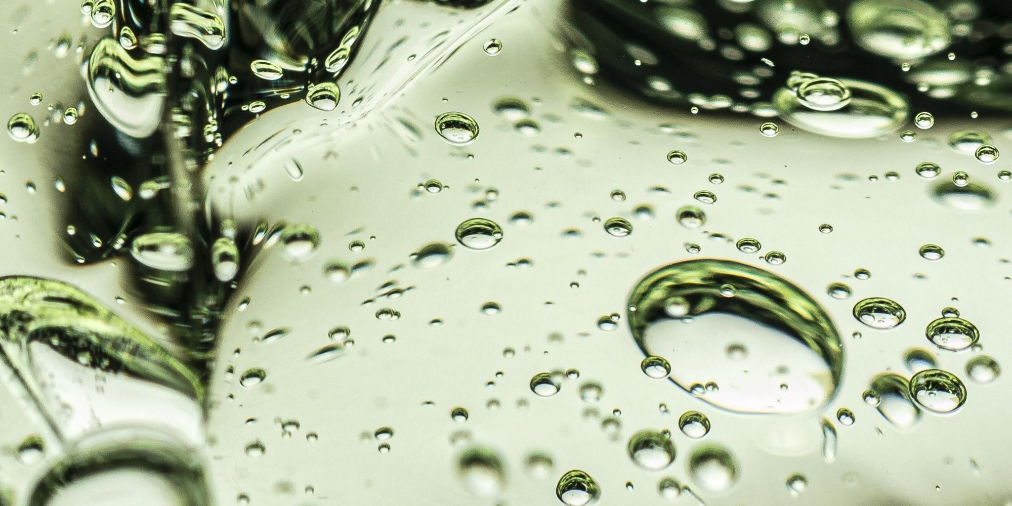 Close up green-tinted clear gel with bubbles