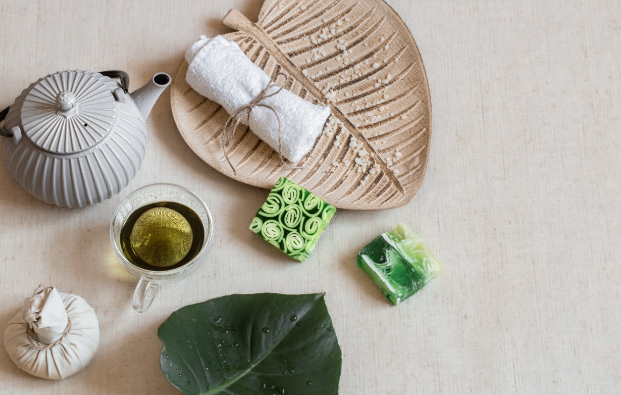 Calming cup of green tea with folded towel