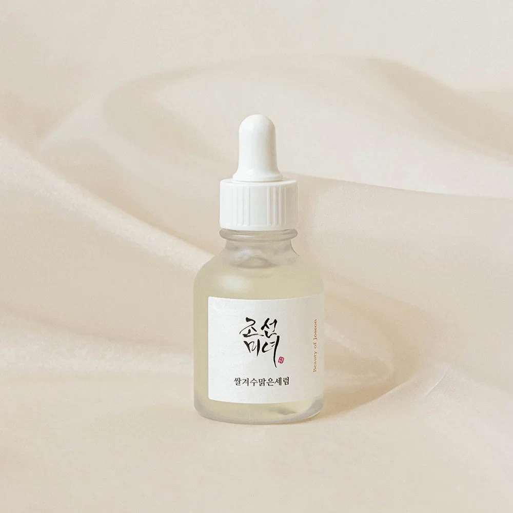Beauty of Joseon Glow Deep Serum sitting on a white, fabric backdrop