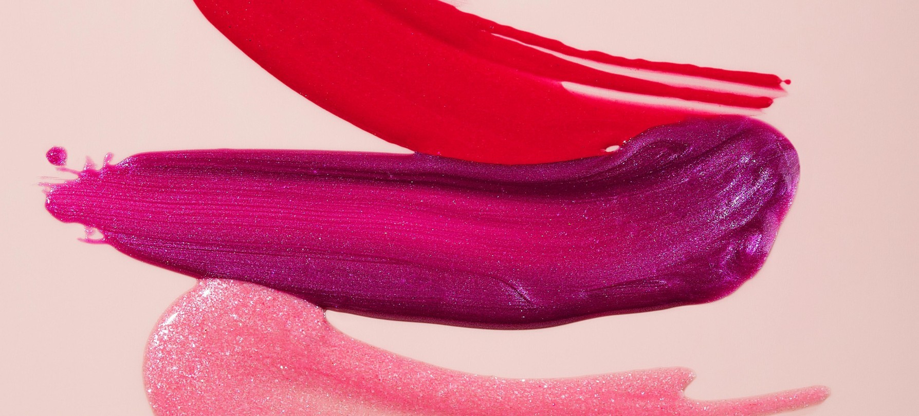 Streaks of different lip colours on a beige background