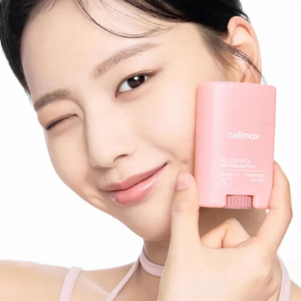 Model holding the Celimax Oil Control Mattifying Sun Stick