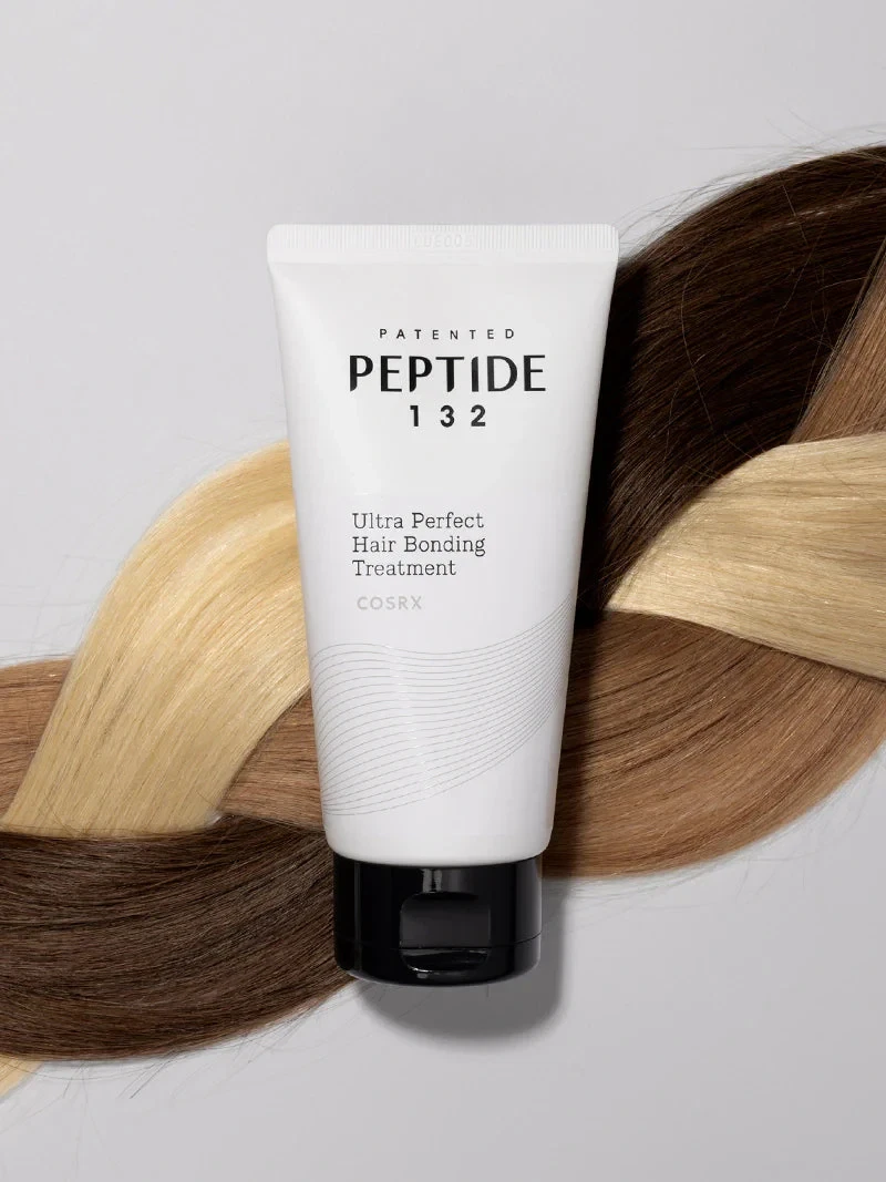 Cosrx Peptide-132 Treatment lying on a braid of multi-colored hair