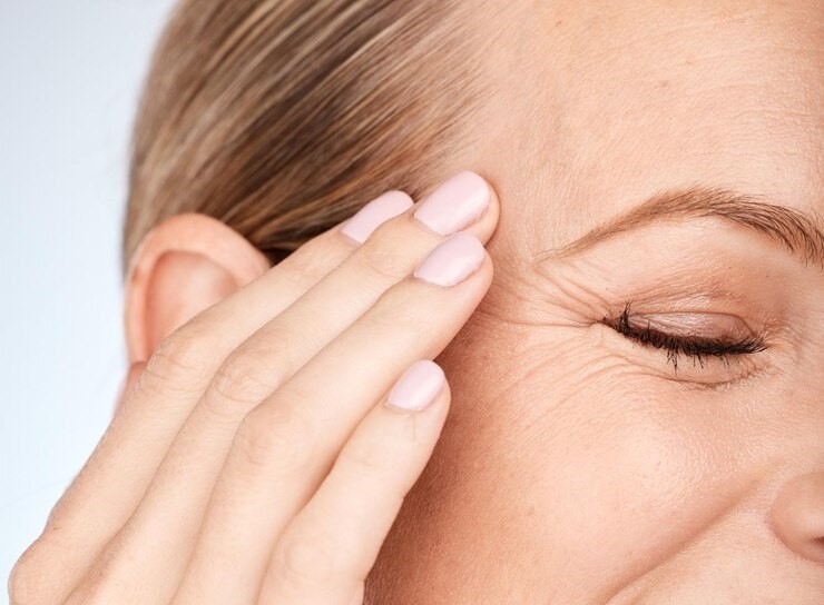 Close up laughing woman showing smile lines of eye