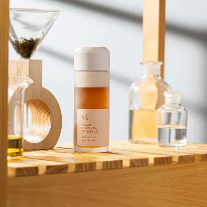 Dr Ceuracle Vegan Kombucha Essence toner in a green tea brewing set up in natural sunlight