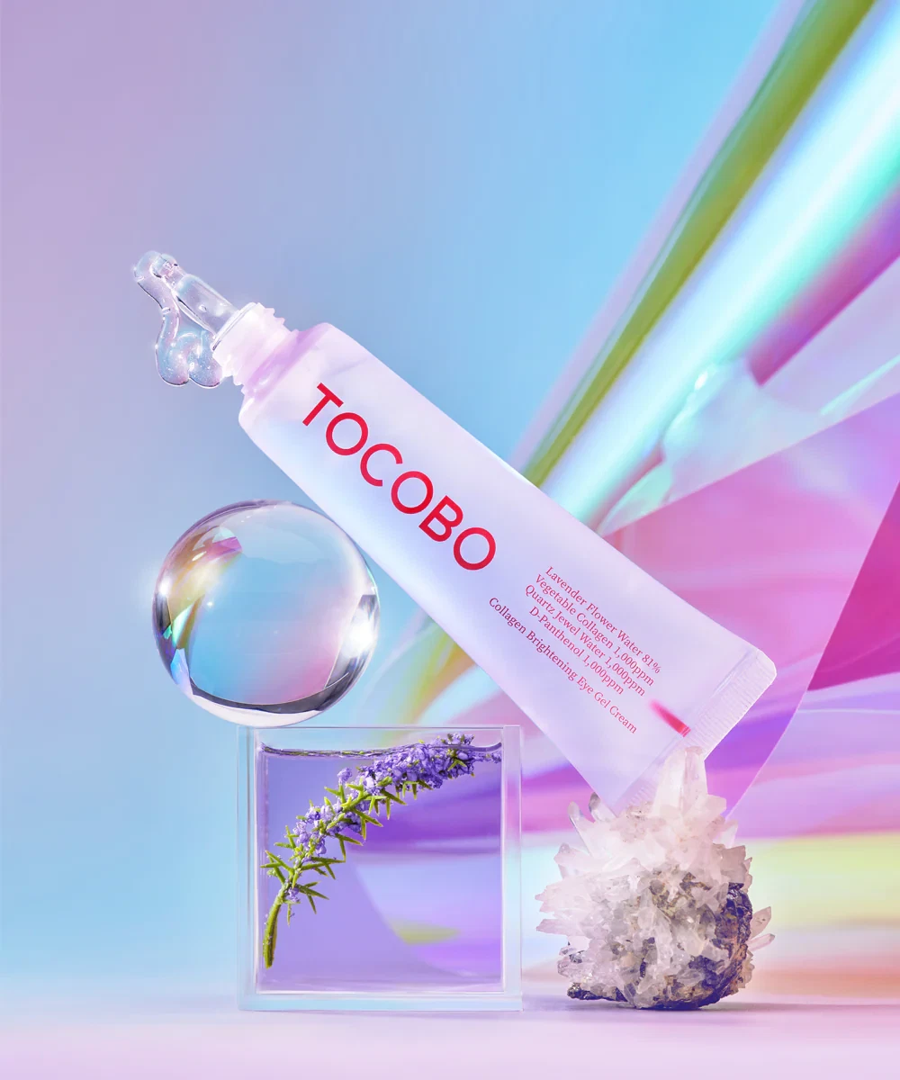 Tocobo Collagen Brightening Eye Gel Cream leaning on glass of lavender in purple water