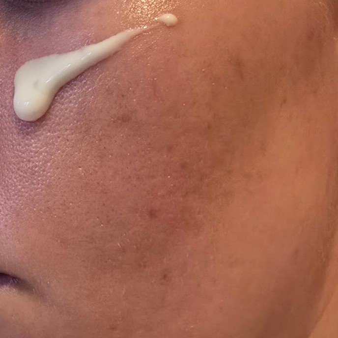 Skin1004 Madagascar Centella Probio-Cica Glow Sun Ampoule dash on cheek