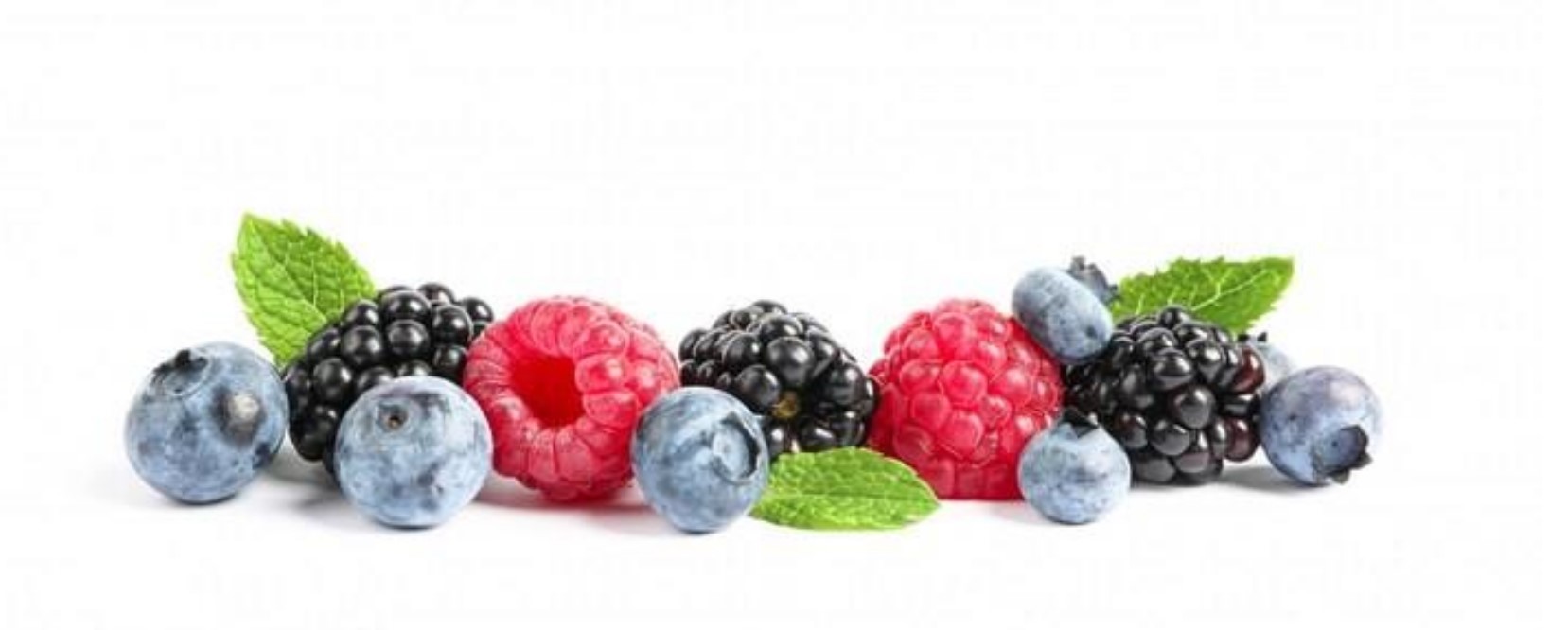 Abundance of small berries lying in a pile (raspberries, blackberries and blueberries)