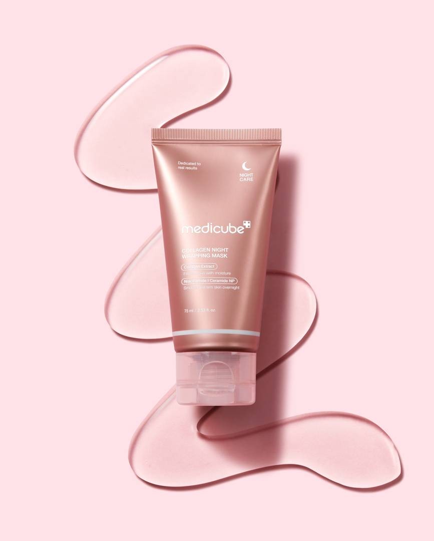 Medicube Collagen Night Wrapping Mask lying on squiggle of clear mask on pink background
