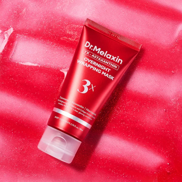 Dr Melaxin TXA-Astaxanthin Overnight Wrapping Mask gliding over red, glittery gel