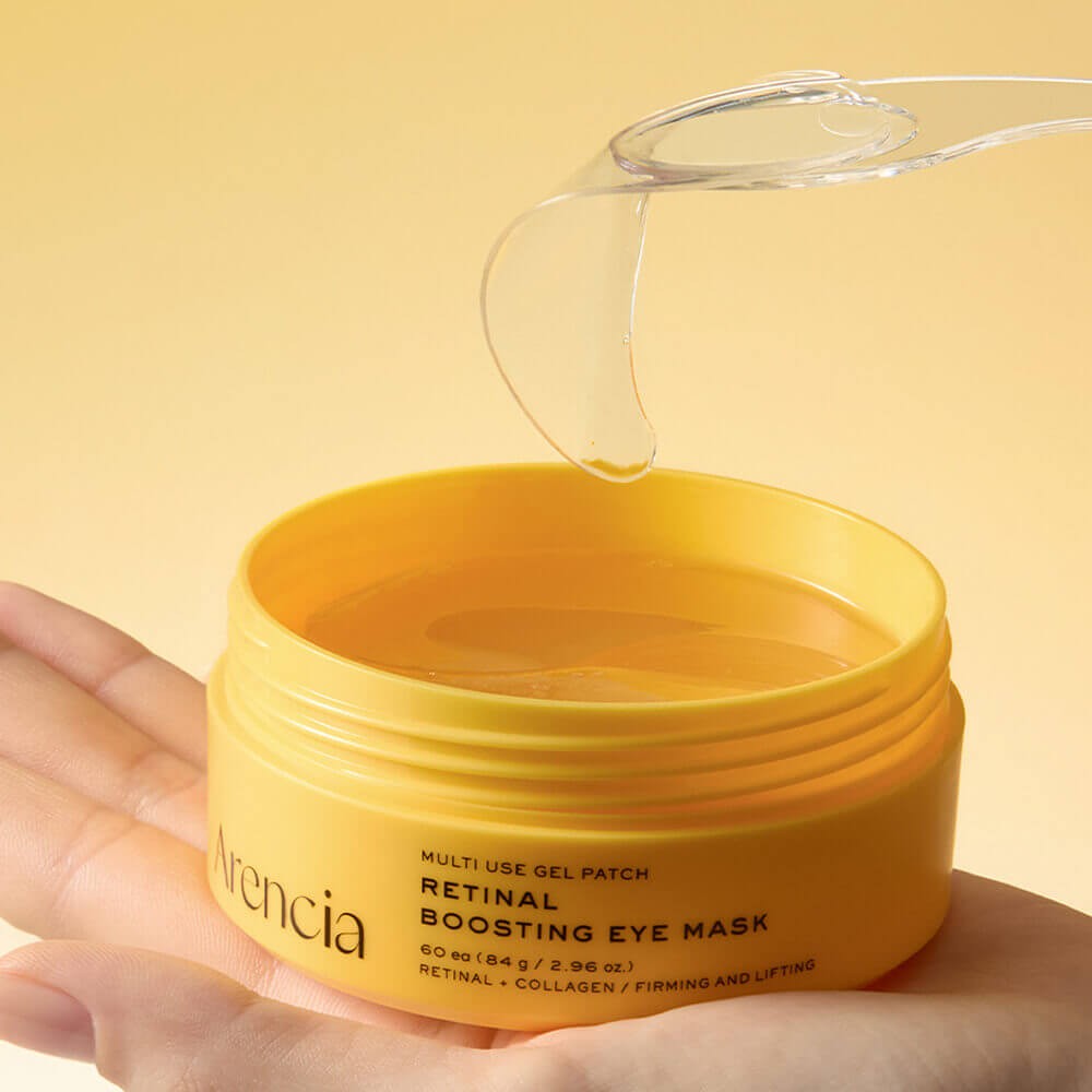 Arencia Retinal Boosting Eye Mask being lifted out of jar