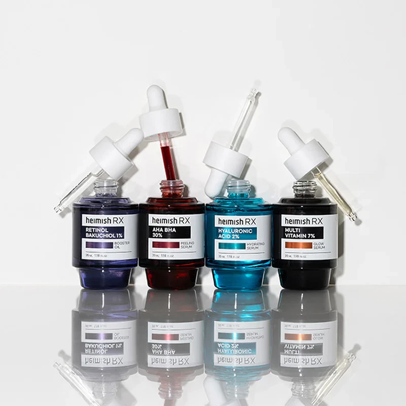 Heimish Rx Serum range with open applicators (from left to right Retinol serum, AHA BHA serum, Hyaluronic acid serum and Multi vitamin serum).