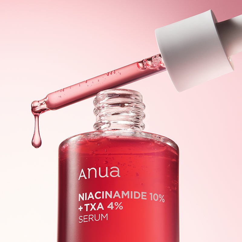 Anua Niacinamide 10% TXA 4% serum with open applicator dripping pink serum