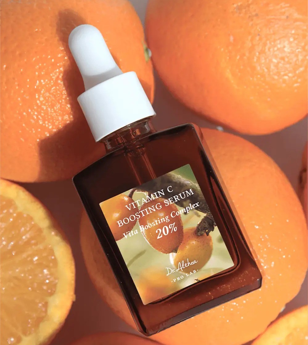 Dr Althea Vitamin C Boosting Serum sitting on cut oranges